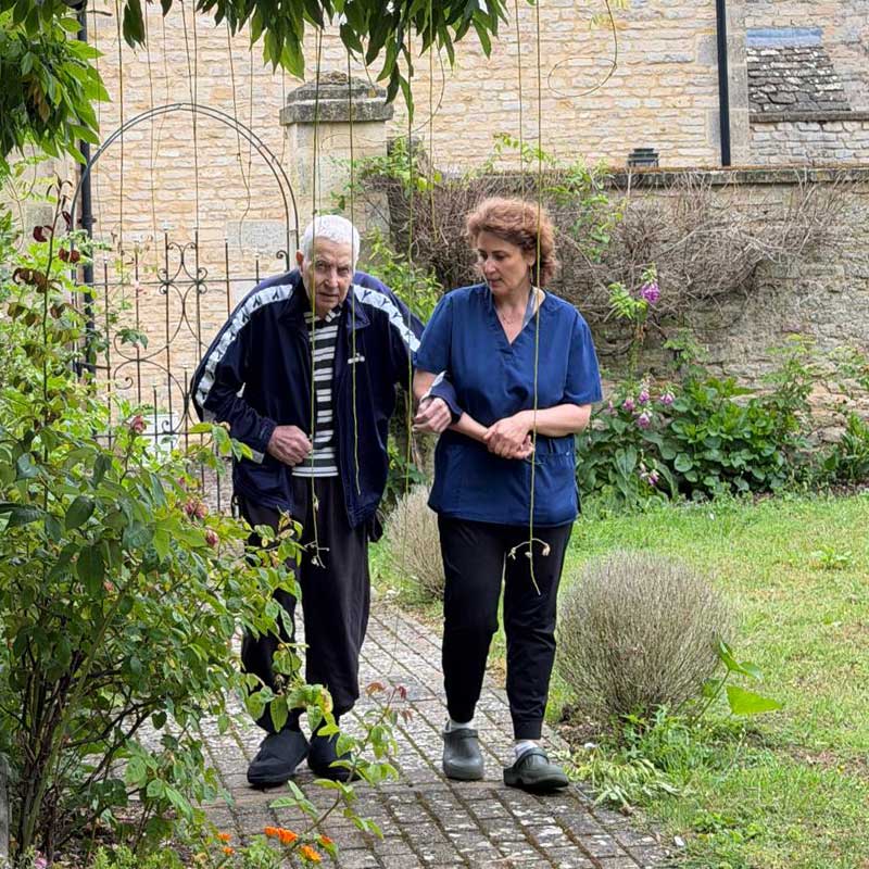 Staff walking with resident